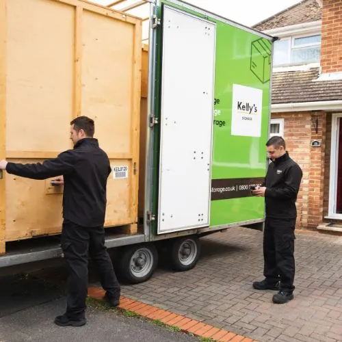 Two self storage professionals loading up a self storage container