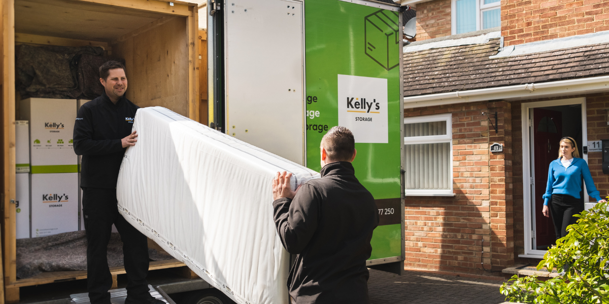 Picture of two self storage workers packing a matters into a mobile storage van